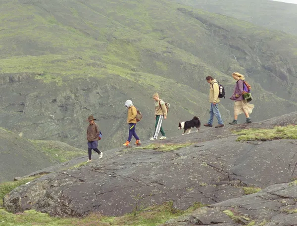Panda in the middle of a line of people walking in The Love That Remains