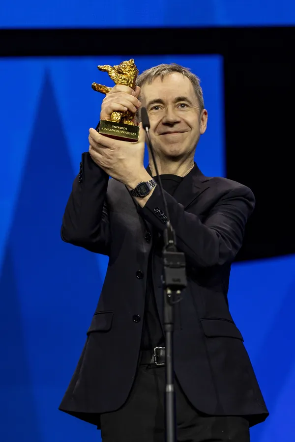 Dag Johan Haugerud holds his Golden Bear for best film aloft