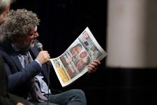 Søren Juul Petersen reads a newspaper reporting on events in Finale