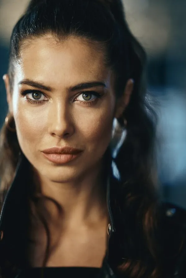 A young woman with light brown skin and long dark hair.