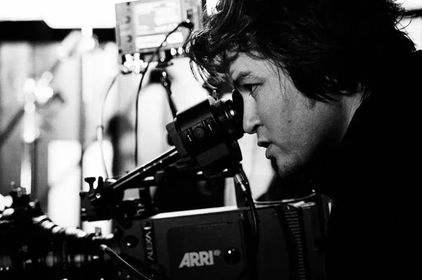 Aboozar Amini looking through a camera