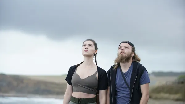 Anamaria Vartolomei and Julien Manier. A thin white woman and a bearded white man look up at the sky.