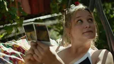 Grete (Anna König), with a polaroid camera as her constant companion.