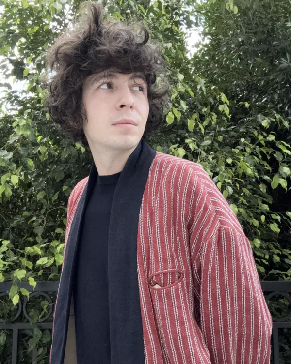 Ugo Bienvenu in a striped blazer