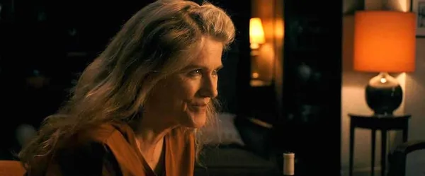 A still from the film Two Of Us. A white woman with long grey hair leans forwards.