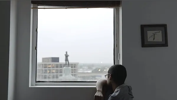 CJ Hunt staring at the Robert E Lee statue in New Orleans