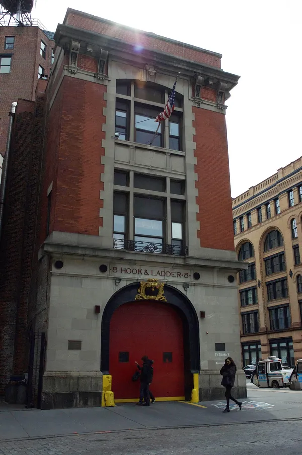 The New York City fire station made famous by the film Ghostbusters. A tall brick building with an arched entranceway around red doors.