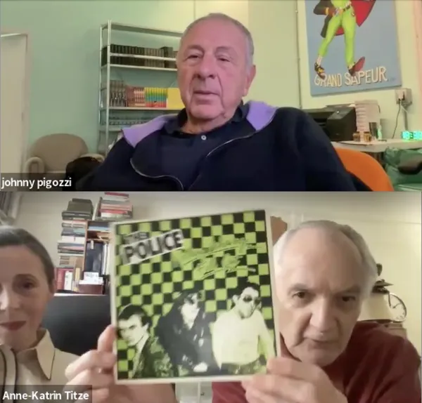 A middle-aged white woman and older white man hold up a vinyl record whose black and chartreuse checked cover says 'The Police' on it.