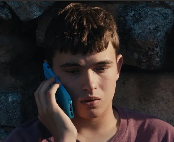 A boy talking on a mobile phone