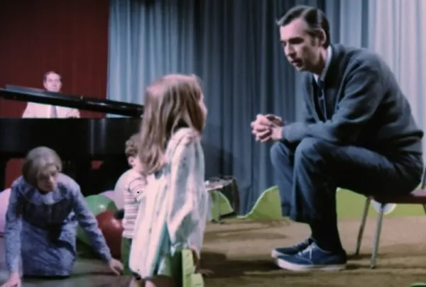 Fred Rogers with an inquisitive young girl