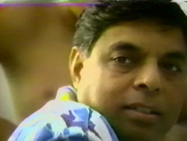 A man looks at the camera in this still from a home video