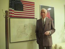 Gay Talese with the American flag painting in the bunker at home