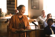 Sandy (Harriet Sansom Harris) speaking at the weekly town hall meeting