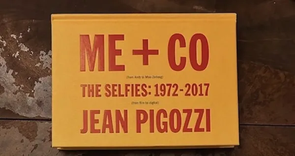 A yellow book with red lettering which reads Me and Co The Selfies 1972 to 2017, Johnny Pigozzi