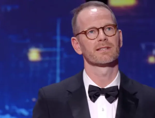 Joachim Trier in a bowtie and suit