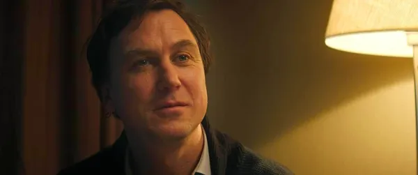 A still from the film Dead Language. A tearful white man sits in a bedroom.