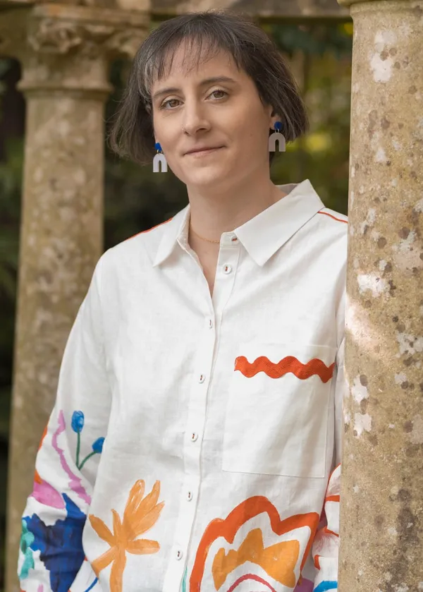 Louise Bagnall wearing a white shirt with colourful decoration