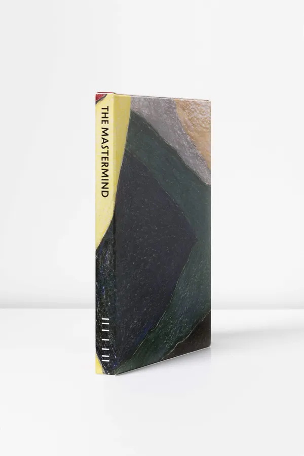 A slender, colourful slip case with the words 'The Mastermind' written on its spine.