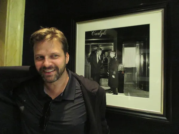 Matthew Miele outside Bemelmans Bar in front of a John F Kennedy photo at The Carlyle Hotel, on Woody Allen: "He used to play at Michael's Pub and now he plays here ..."