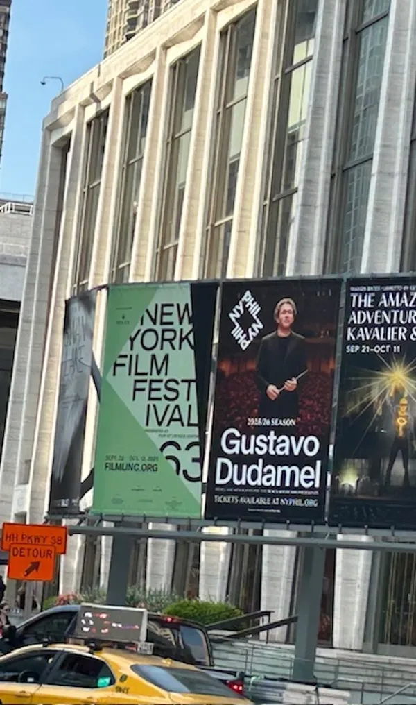 Posters for the New York Film Festival and Gustavo Dudamel on the side of a pale modern building.