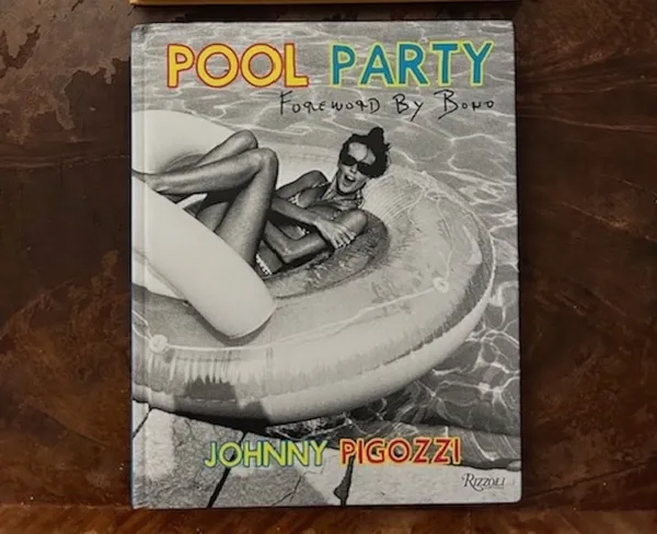 A book  titled 'Pool Party' with a black and white cover image of a white woman lounging on a pool inflatable, and the name Jean Pigozzi.