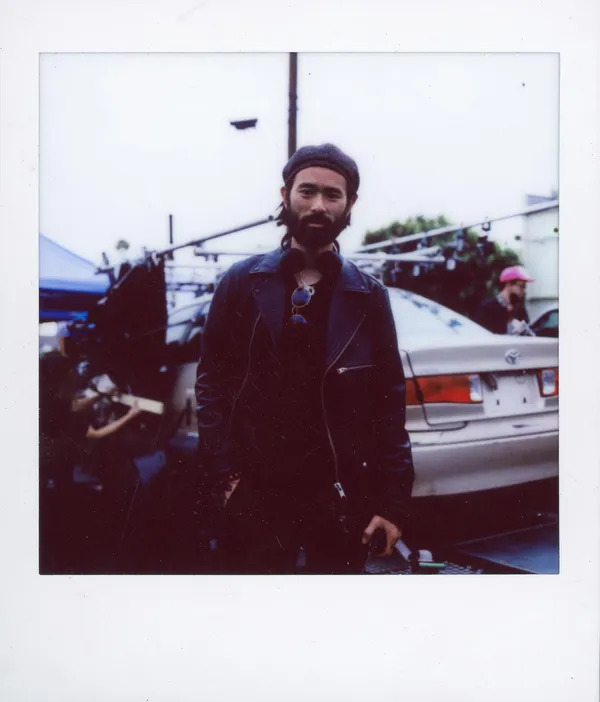 A polaroid shot of director Sing J Lee