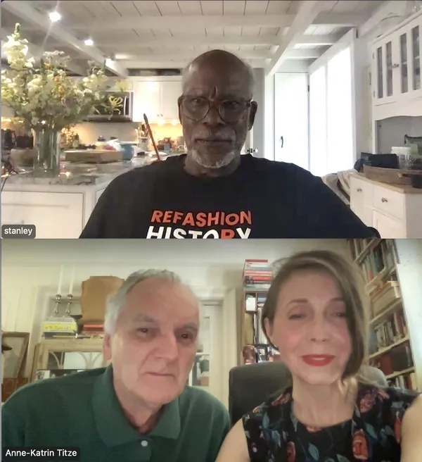A bespectacled middle-aged black man wearing a T-shirt with the words 'refashion history' sits in a kitchen in one Zoom window; an older white man and a middle-aged white woman sit in a book-lined room in another.