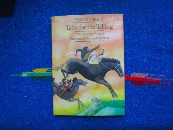 The book Tales For The Telling, against a vivid blue background.