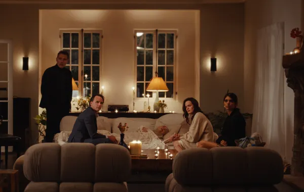 A still from the film The Uninvited. Four white people gathered in an expensively decorated living room look round with concerned expressions.