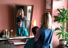 Marianne (Marie Colomb) giving Philippe (Thimothée Robart) a haircut at Élysée Coiffure