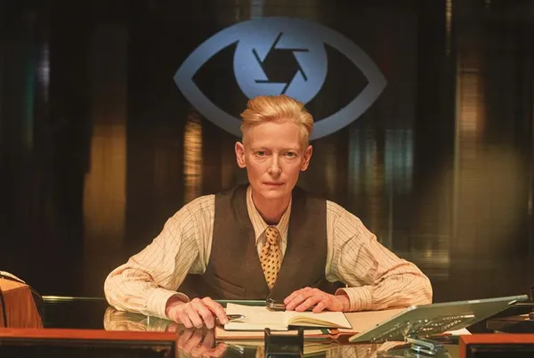 A woman sits at a desk