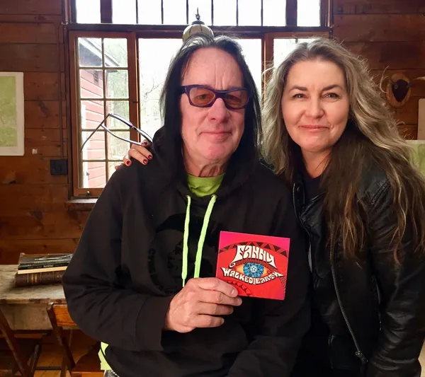 Todd Rundgren holding up a Fanny Walked The Earth CD with Bobbi Jo Hart