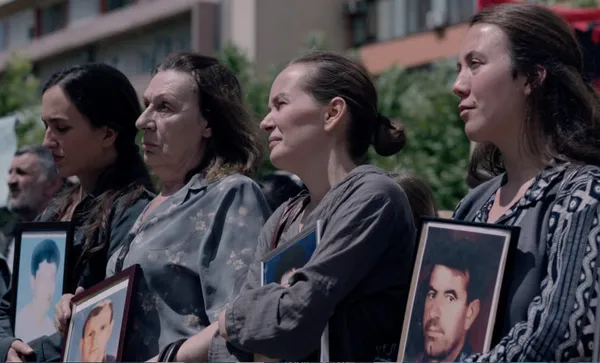 Wives hold pictures of their missing husbands in Hive