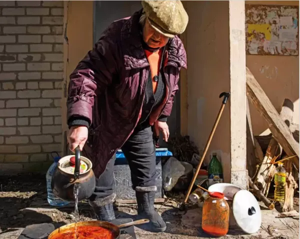 A woman making Ukrainian Borscht in Kupiansk in Slava Ukraini