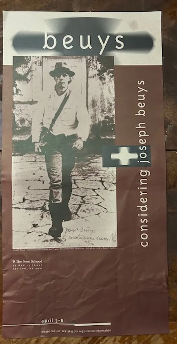 A brown and white flier which says 'considering joseph beuys' down one side and 'beuys' along the top, with a picture of a white man wearing a hat.