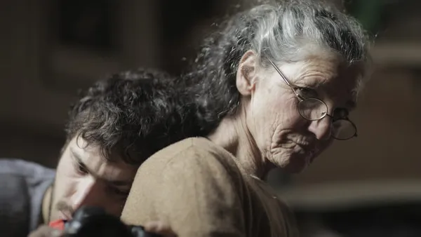 A man hugs an older woman