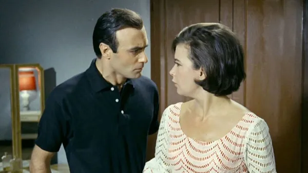 A man and a woman look at one another
