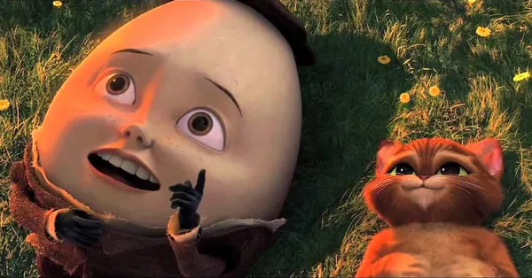 A still from the animated film Puss In Boots. A large egg man lies down beside an orange stripey cat.