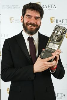 Felipe Bustos Sierra with his award