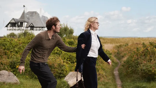 A man grabs a woman's arm as she walks away from him